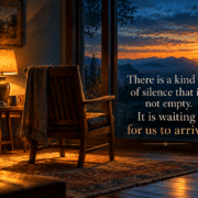 A single empty chair facing a window at dusk, warm lamplight behind it, the room quiet and the light going.